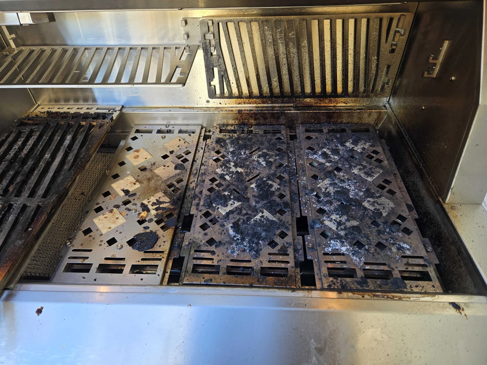 Grill interior with visible cooking residue.