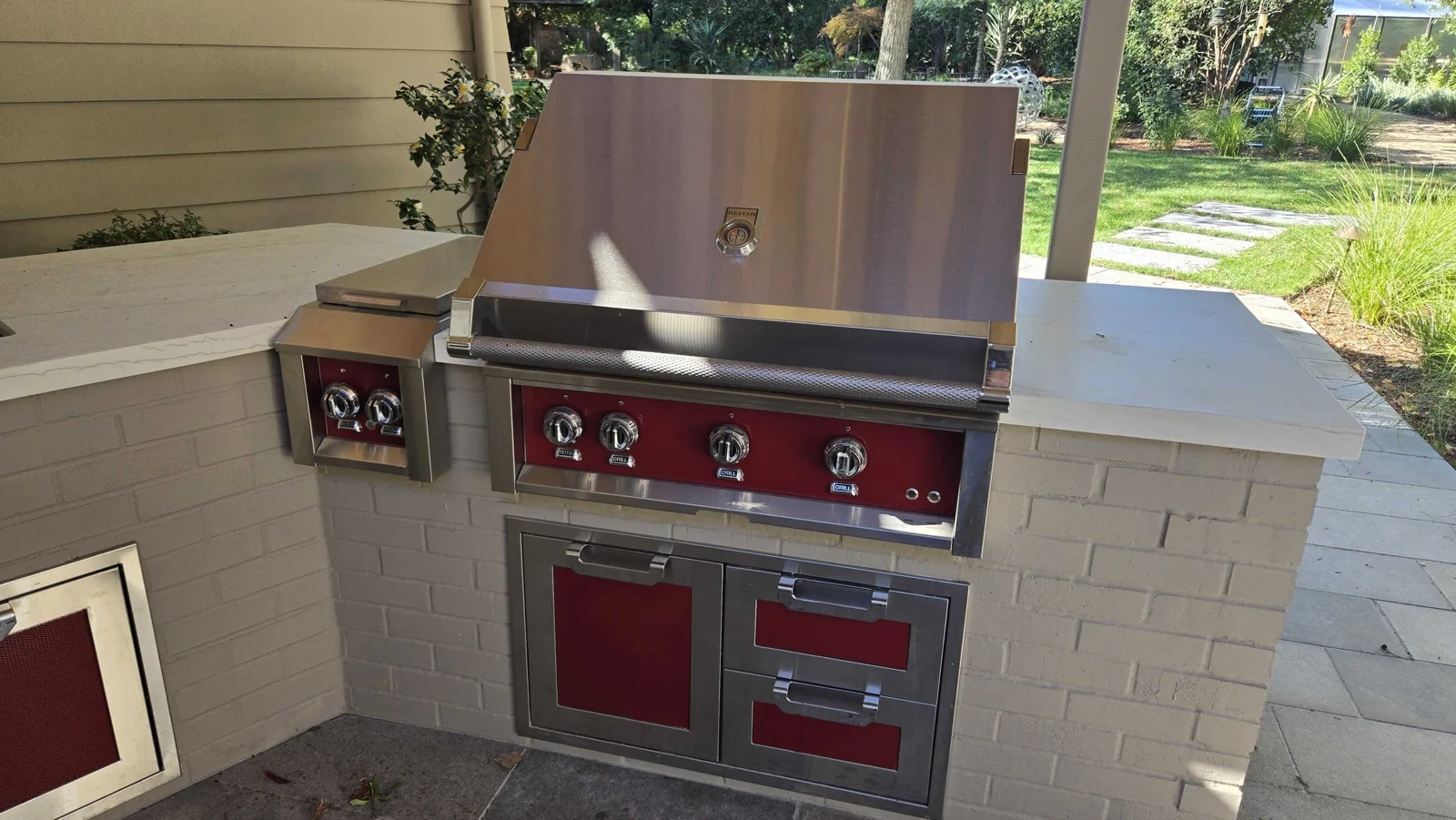 Outdoor Hestan grill with the hood closed.