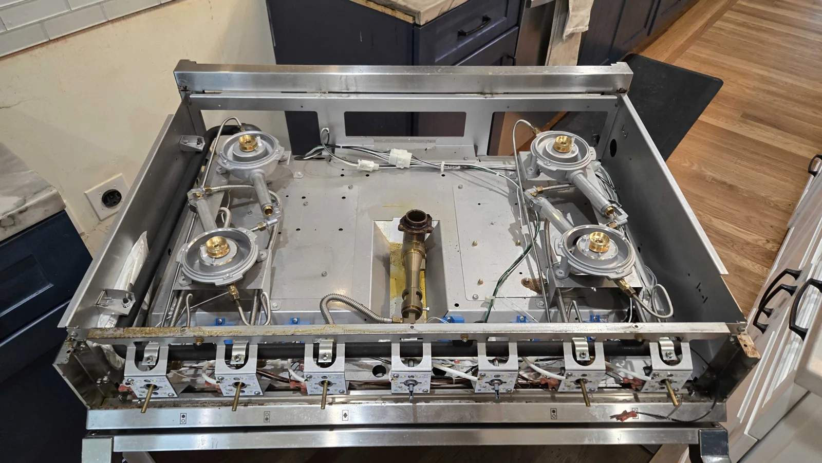 Hestan range burner assemblies exposed during service.