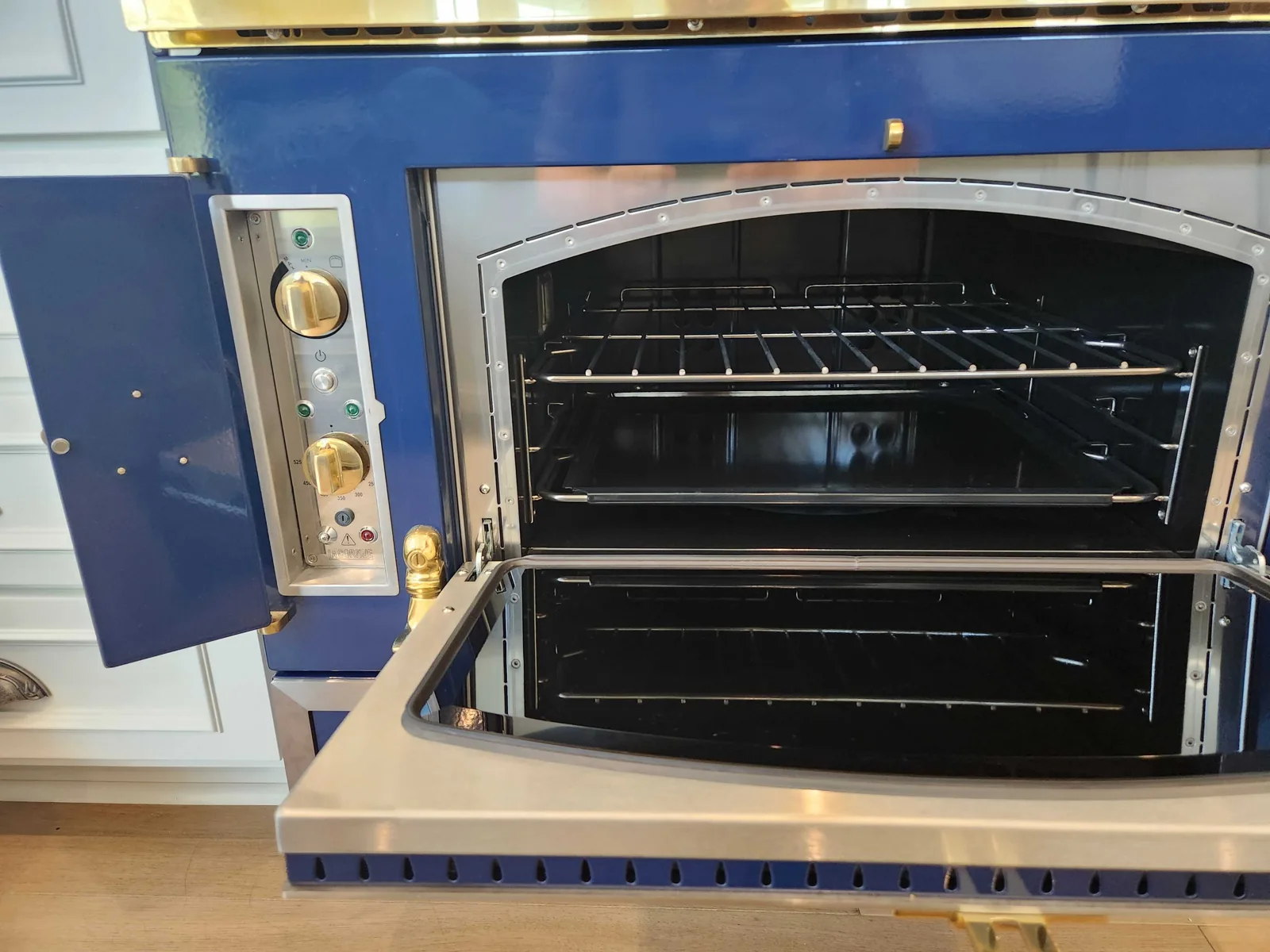 La Cornue oven with the door open and interior racks visible.