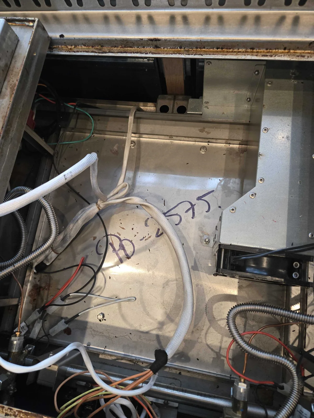 Internal wiring and tubing exposed during service.