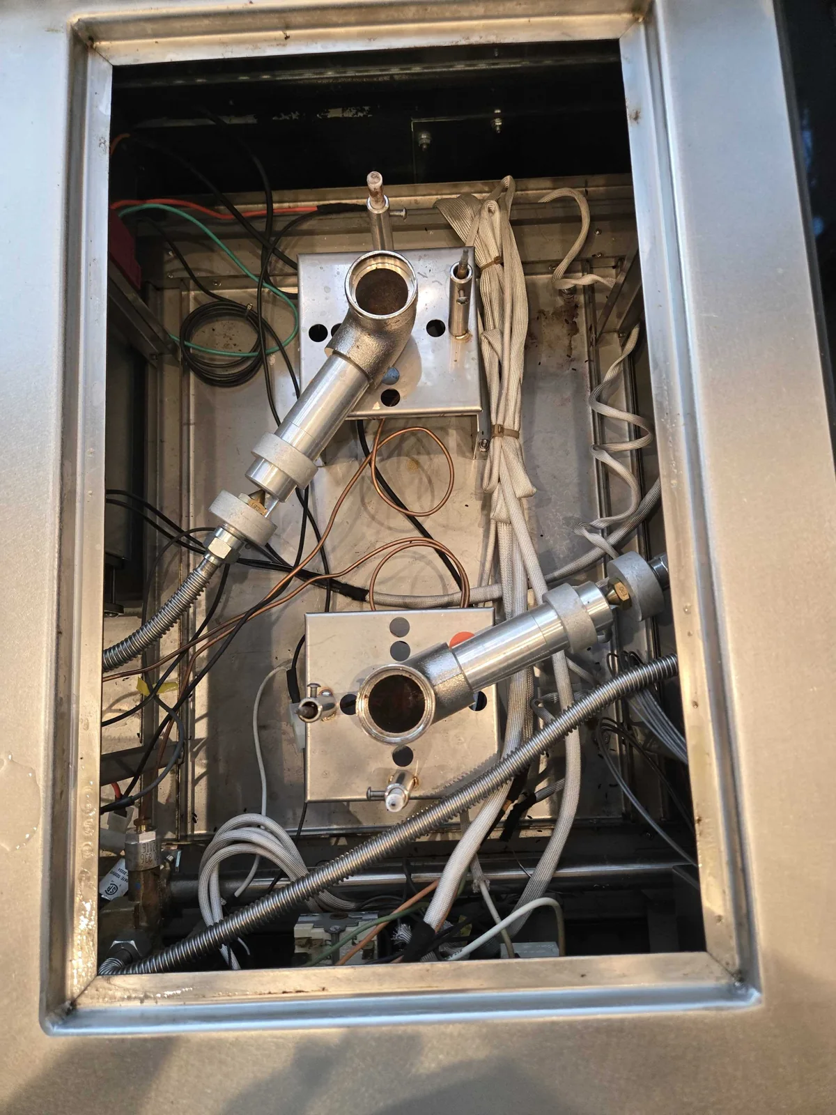 Cooking surface opened to access internal components during service.