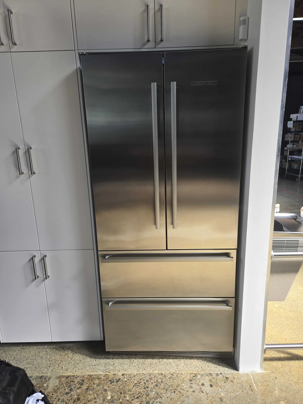 Liebherr refrigerator with stainless-steel doors and freezer drawers.