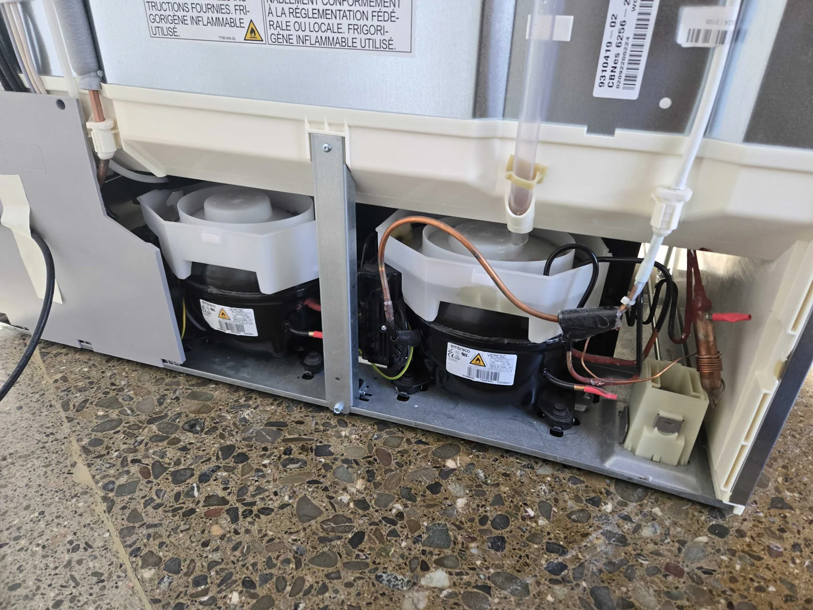 Rear compressor compartment and refrigerant tubing.