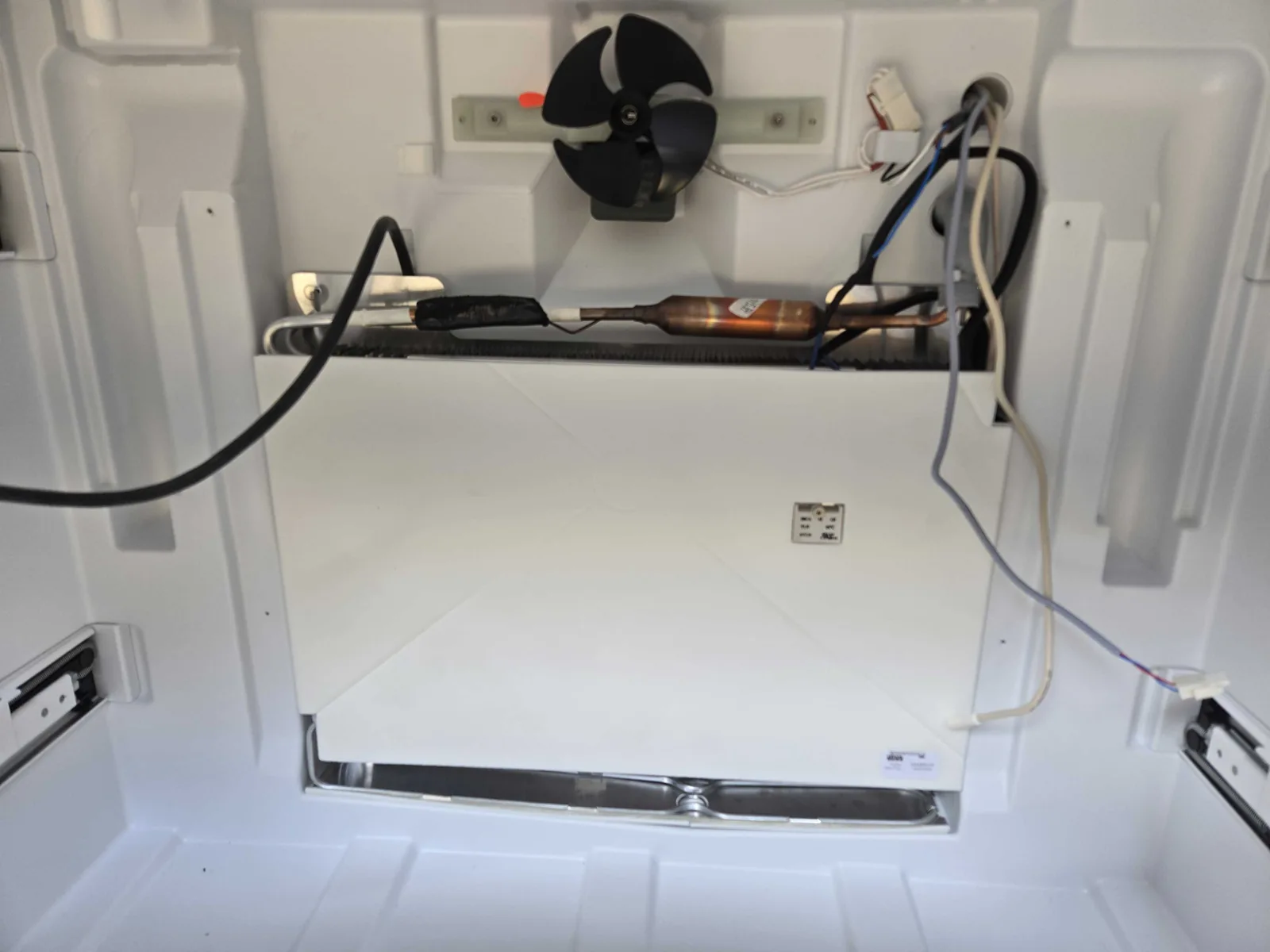 Refrigerator interior with the rear cover removed.