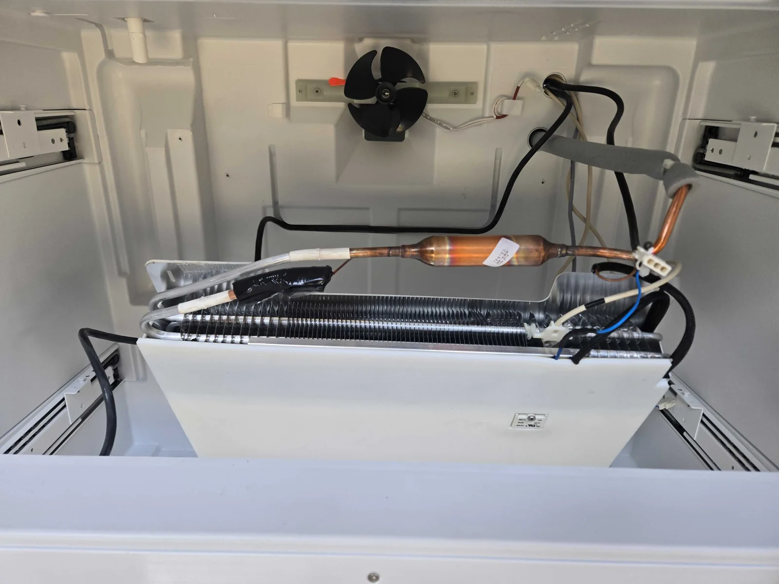 Exposed evaporator, fan and tubing during service.
