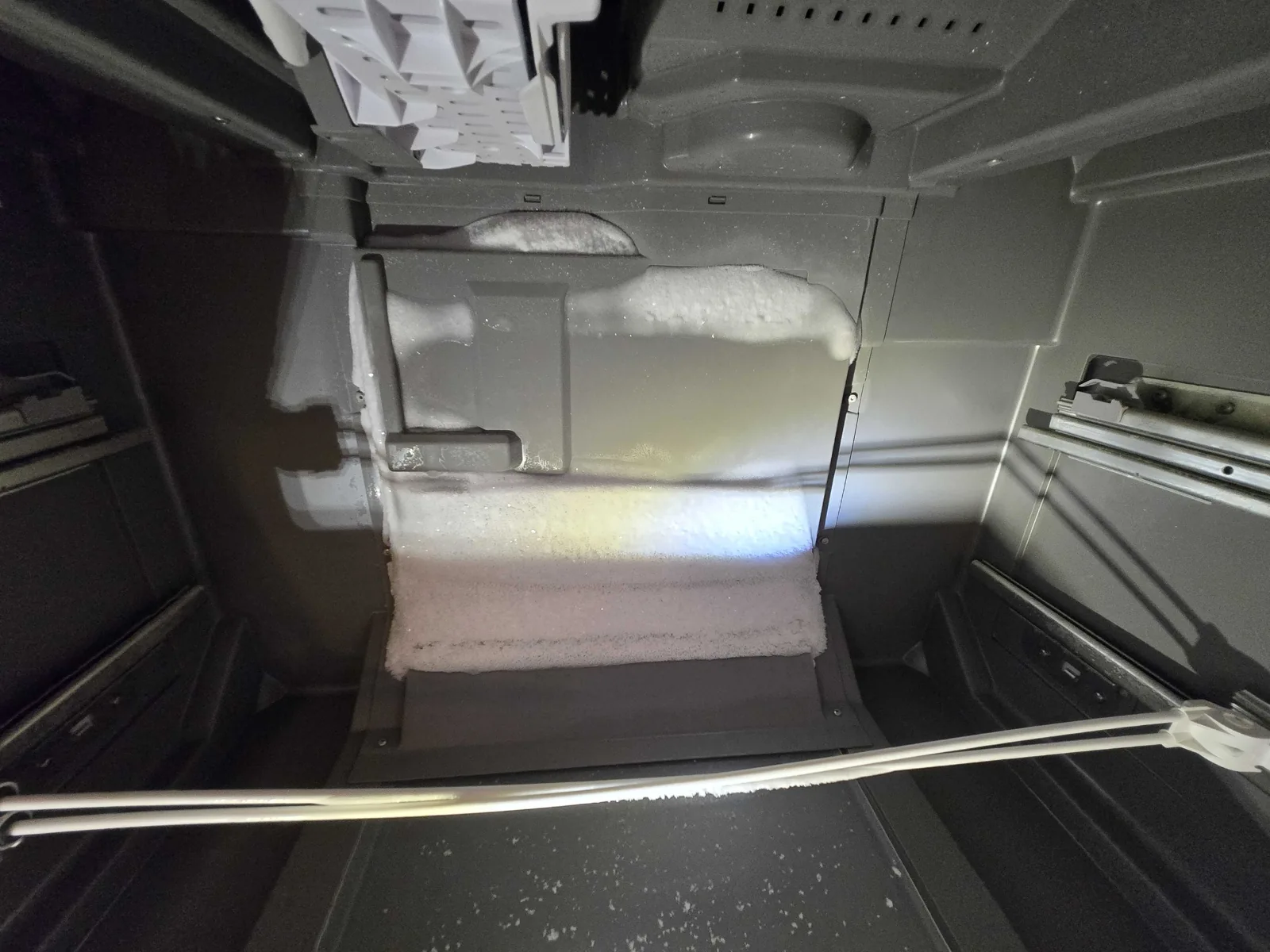 Frost buildup around the rear freezer panel.