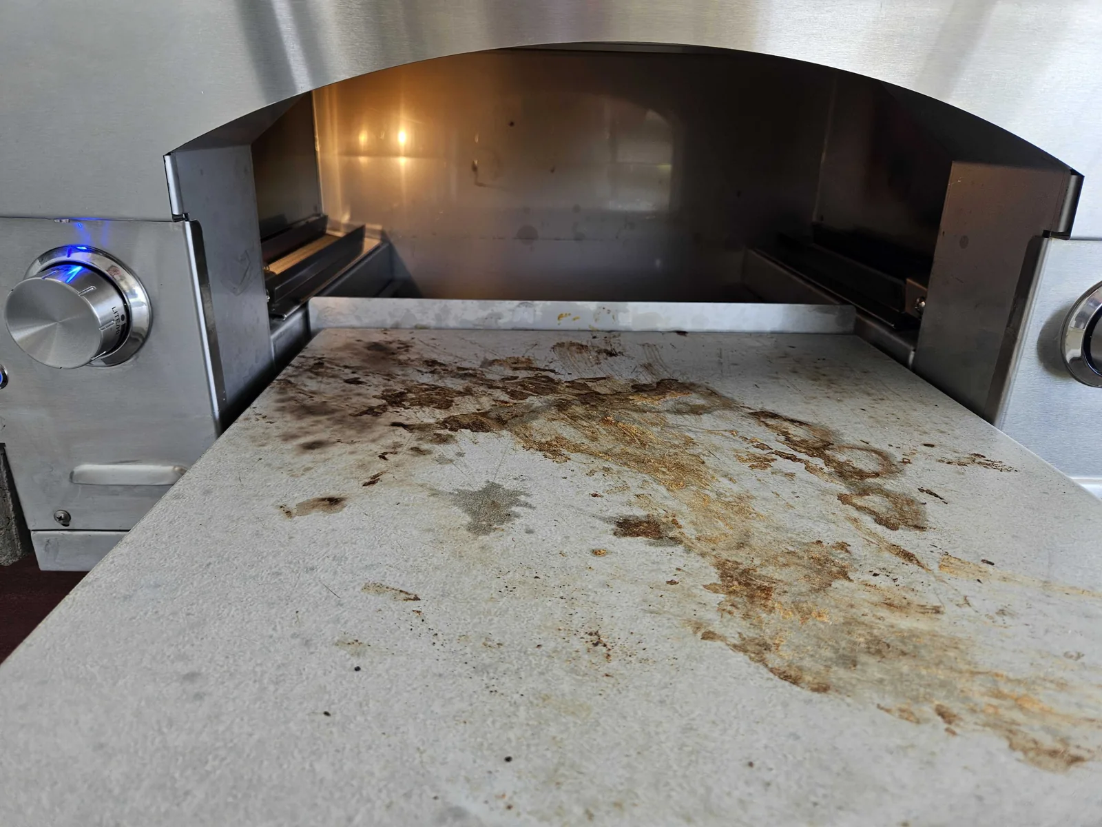 Interior cooking stone and oven opening of a Lynx outdoor pizza oven.