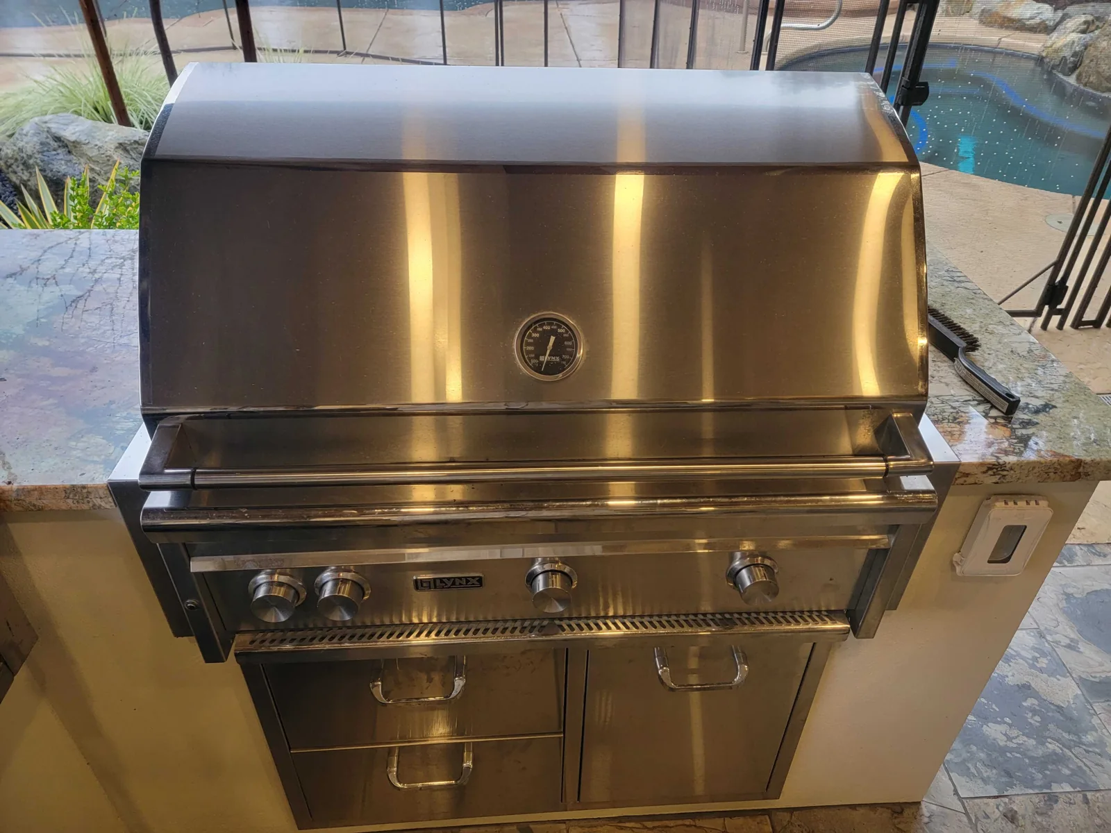 Lynx outdoor grill and cabinet with the hood closed.