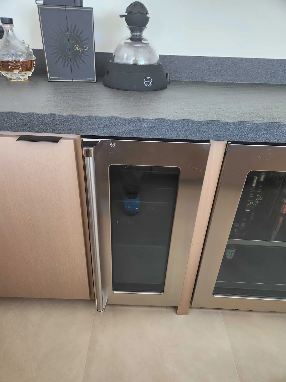 Undercounter glass-door refrigeration installed in a bar area.