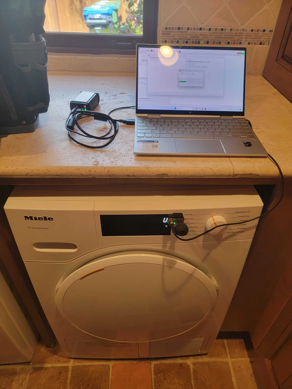 Miele washer with diagnostic equipment connected during service.