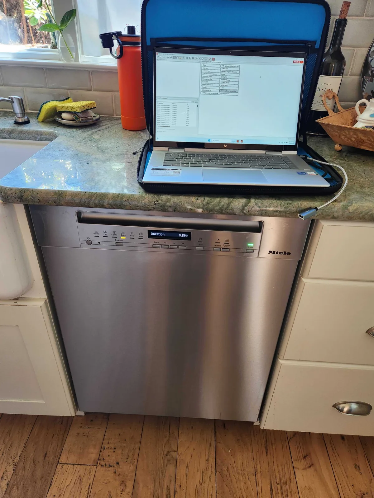 Miele dishwasher with diagnostic equipment connected.