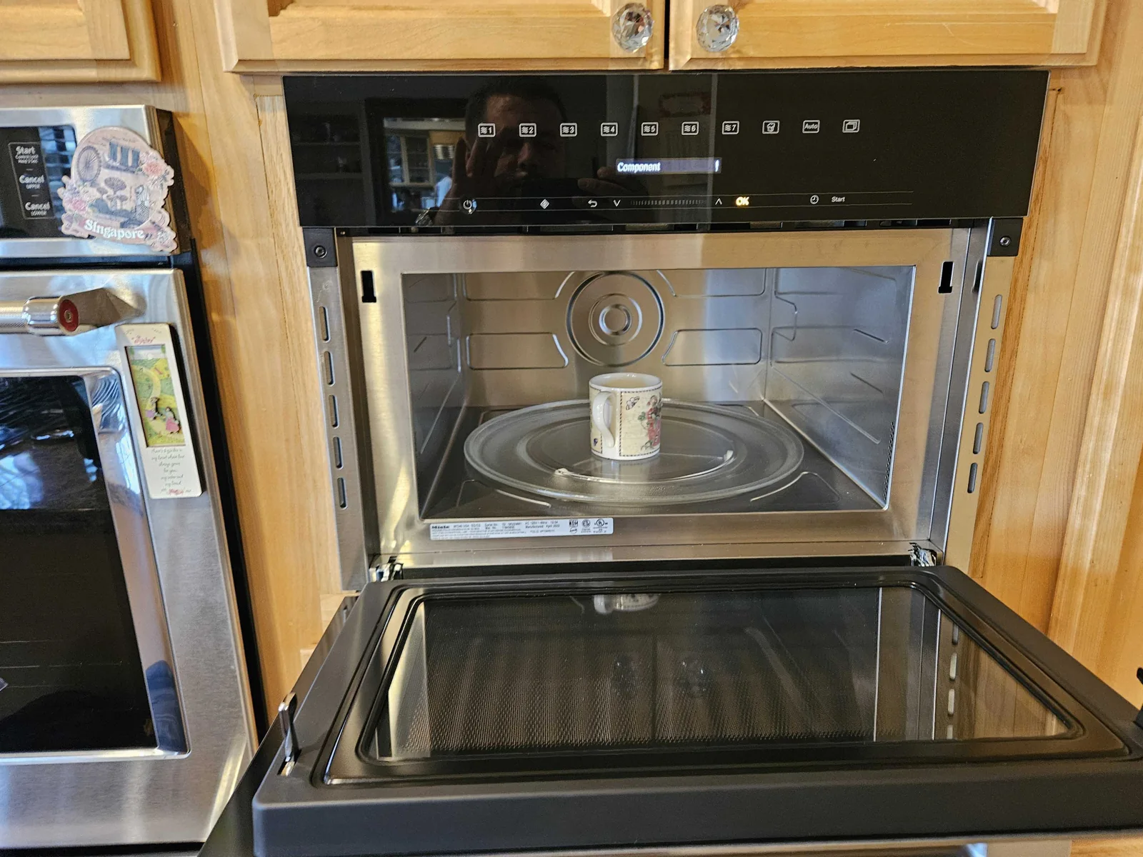 Miele steam oven with its door open and an interior tray visible.