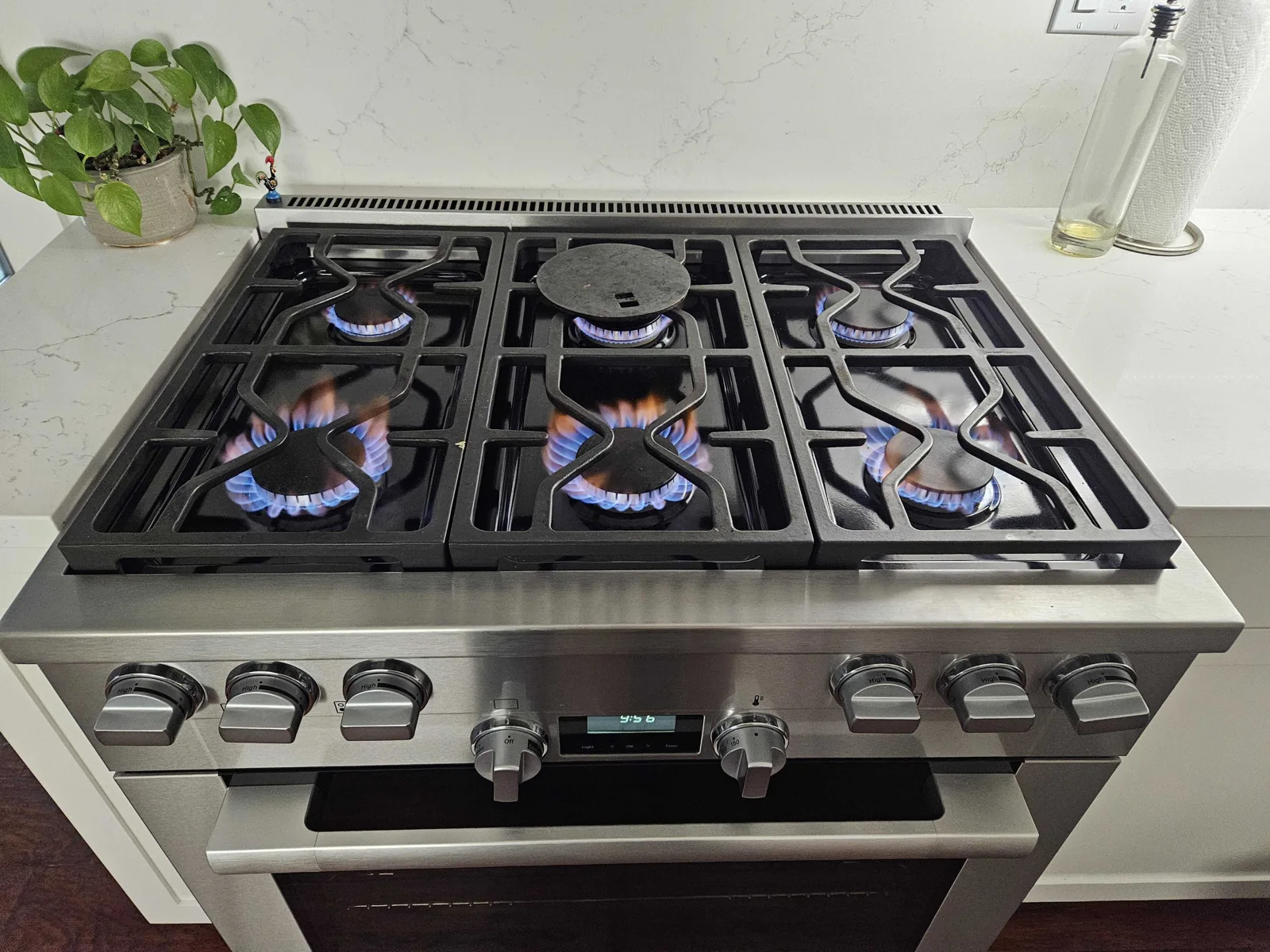 Miele gas range with the burners lit.