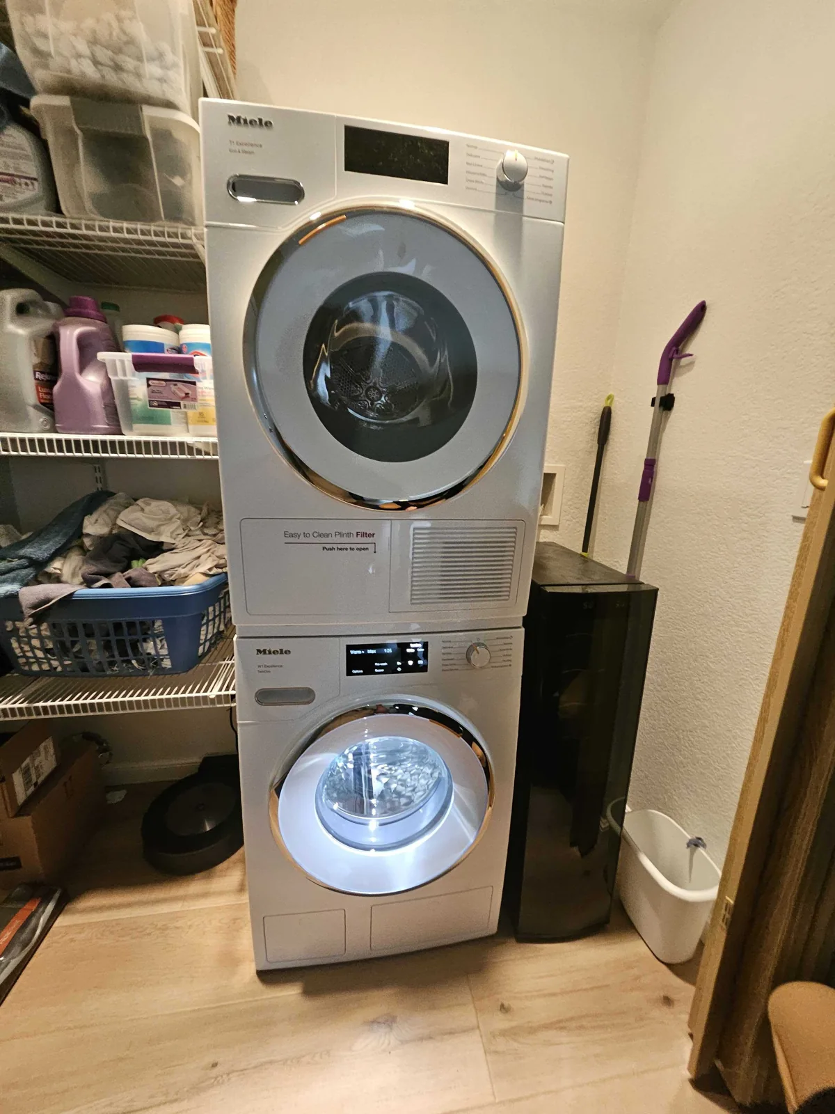 Stacked Miele laundry appliances in a utility area.