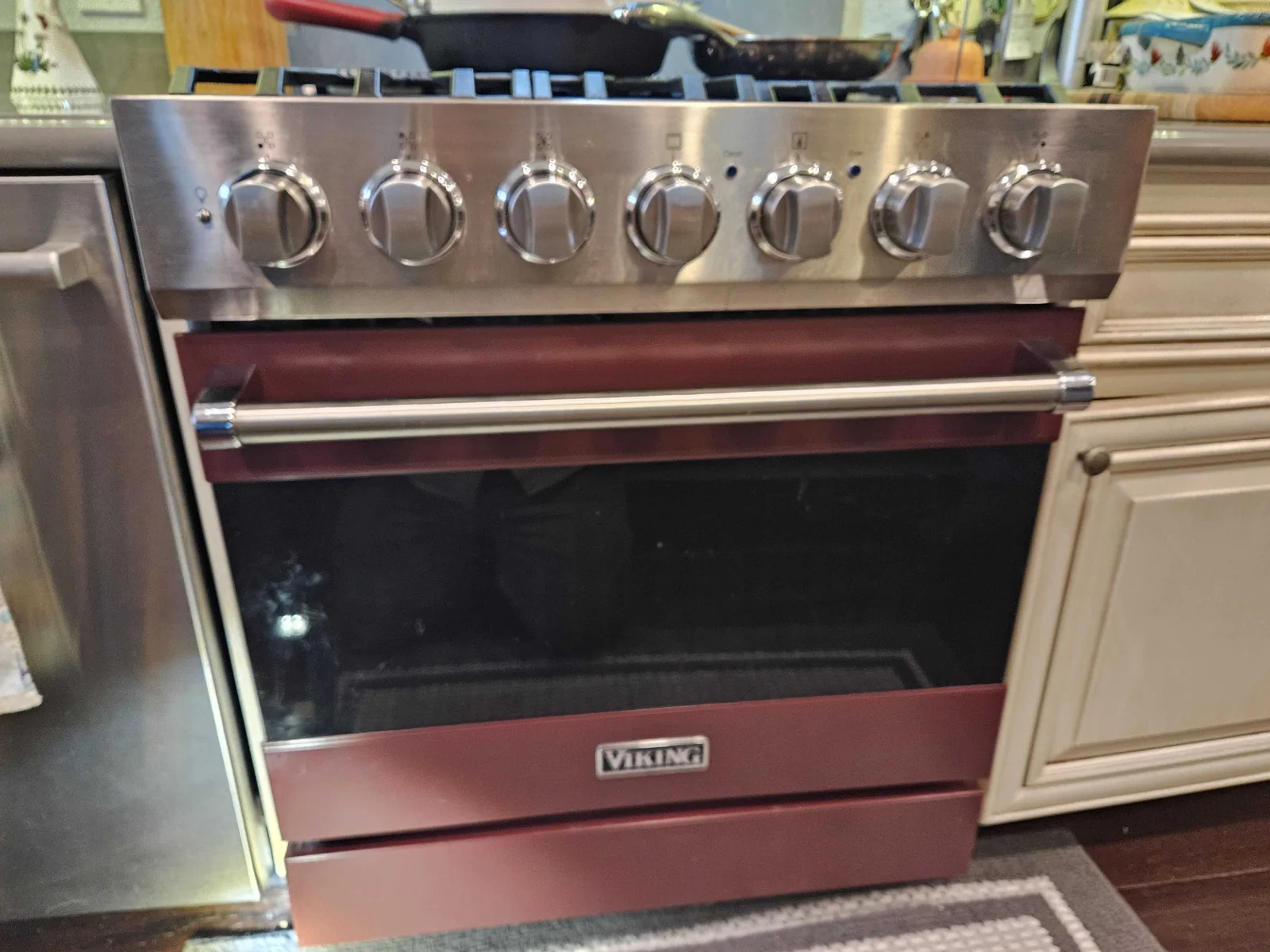 Burgundy Viking range with stainless-steel controls.