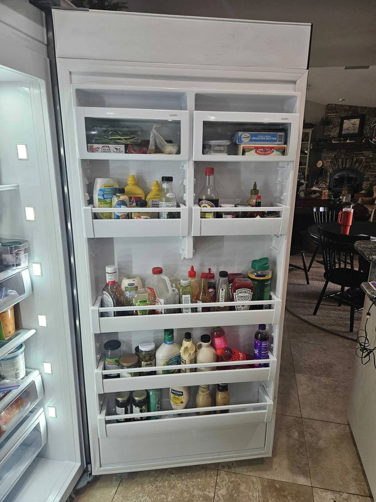 Viking refrigerator with the door open and interior shelves visible.