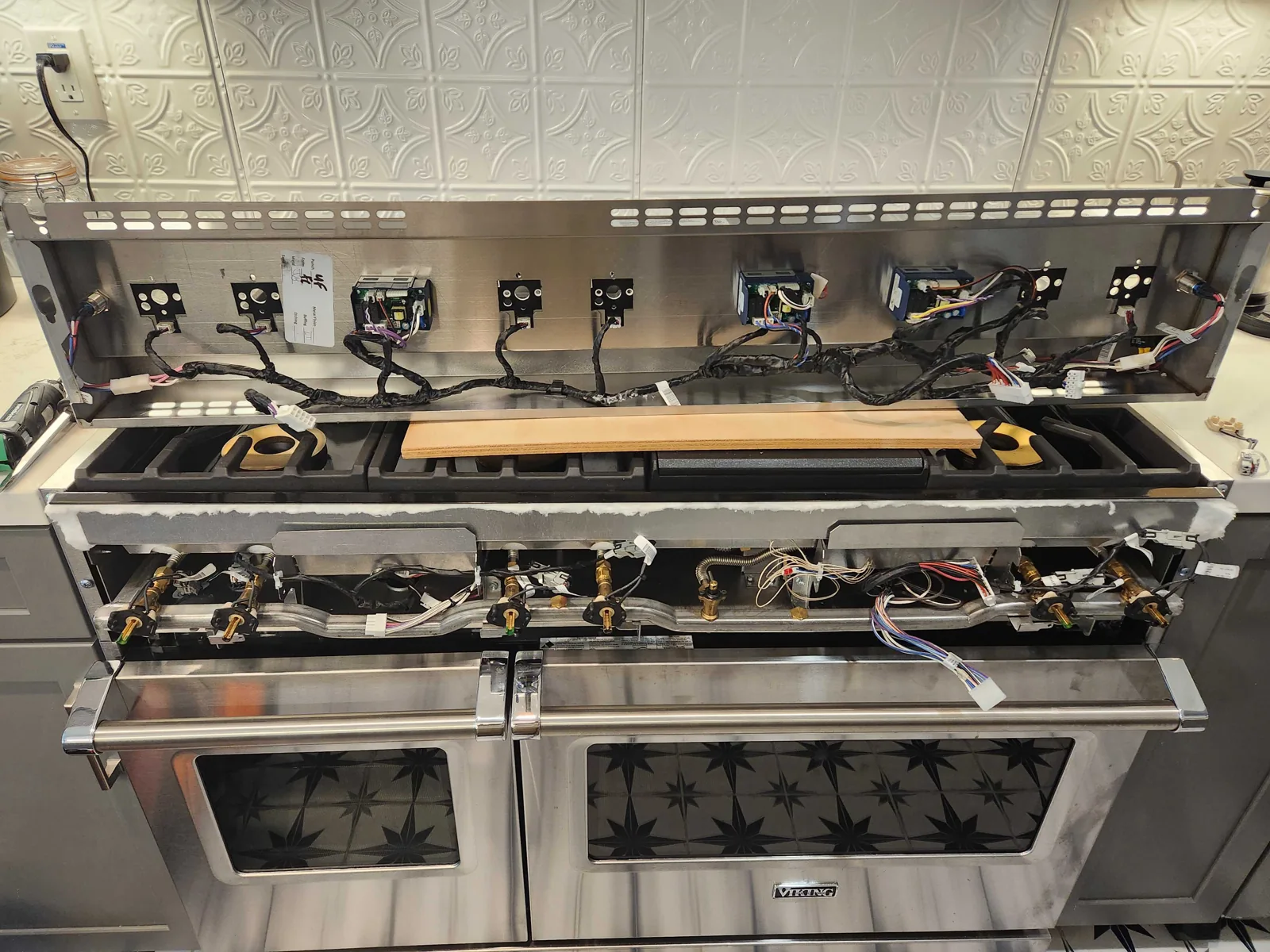 Viking range with the cooking surface removed and internal gas components visible.