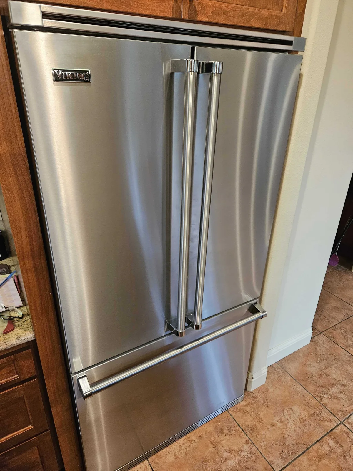 Stainless-steel Viking refrigerator with a bottom freezer drawer.