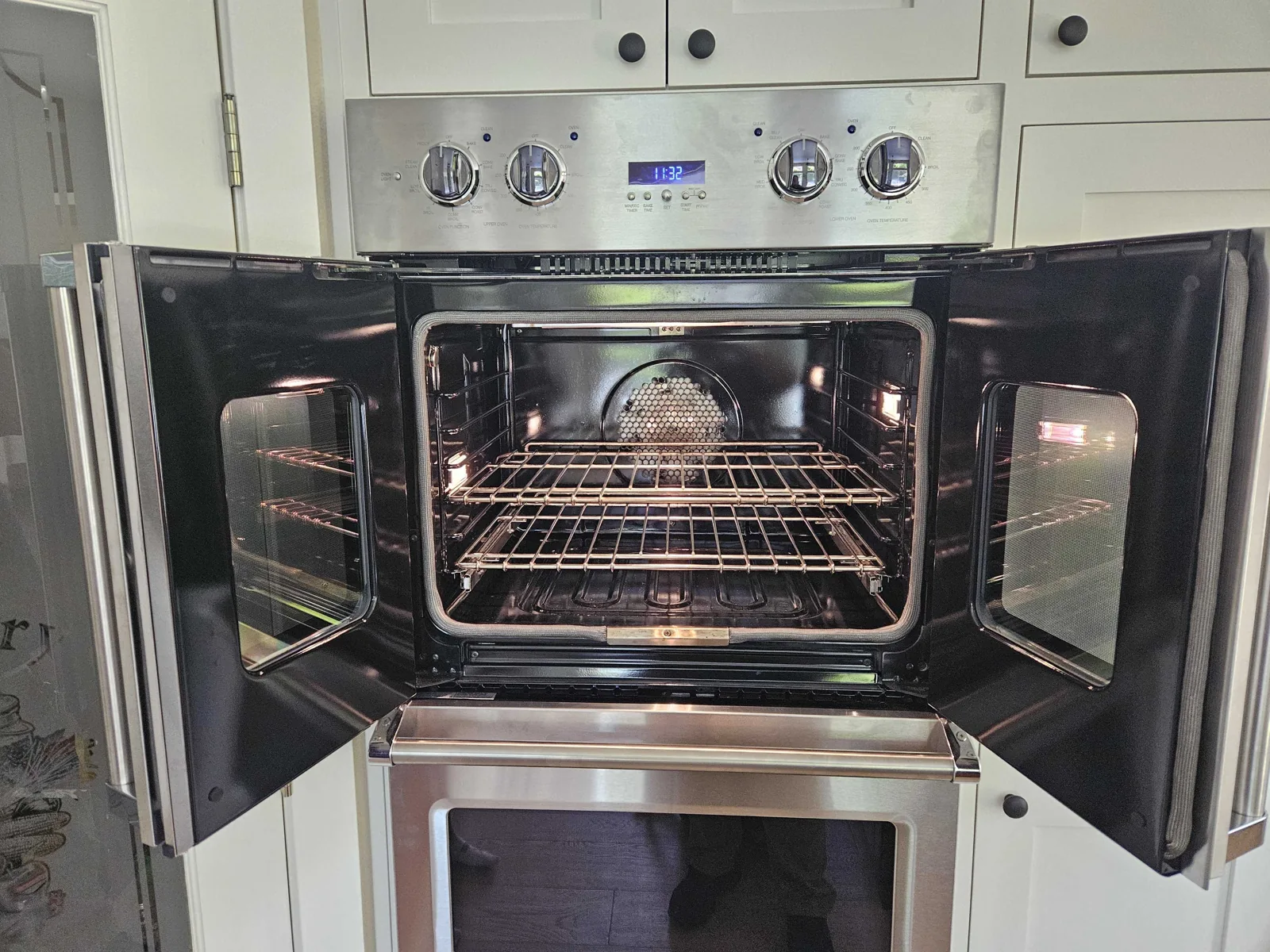 Viking French-door oven with the doors open and racks visible.