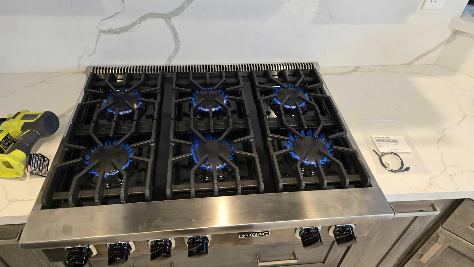 Viking rangetop with burners operating.